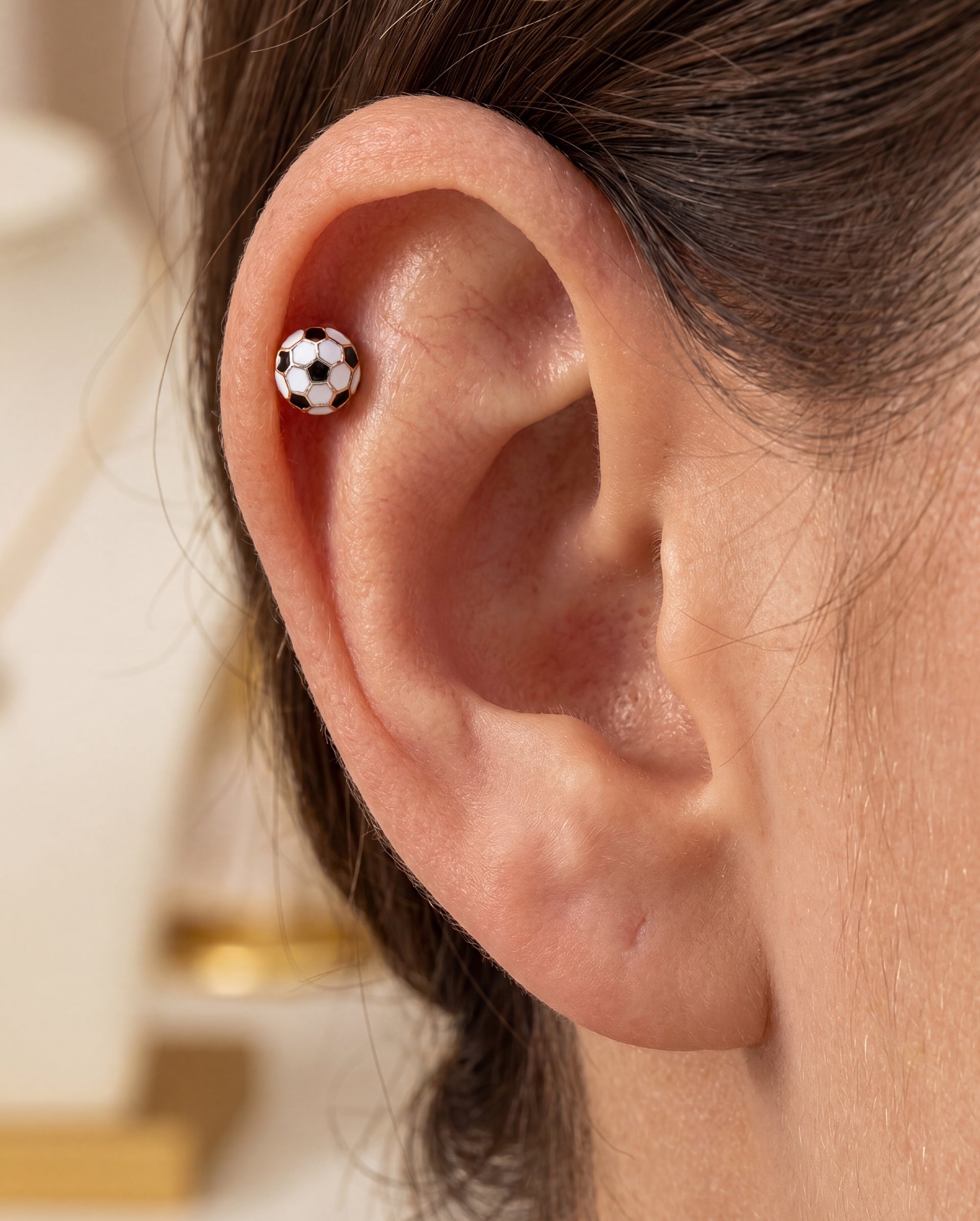 soccer helix piercing