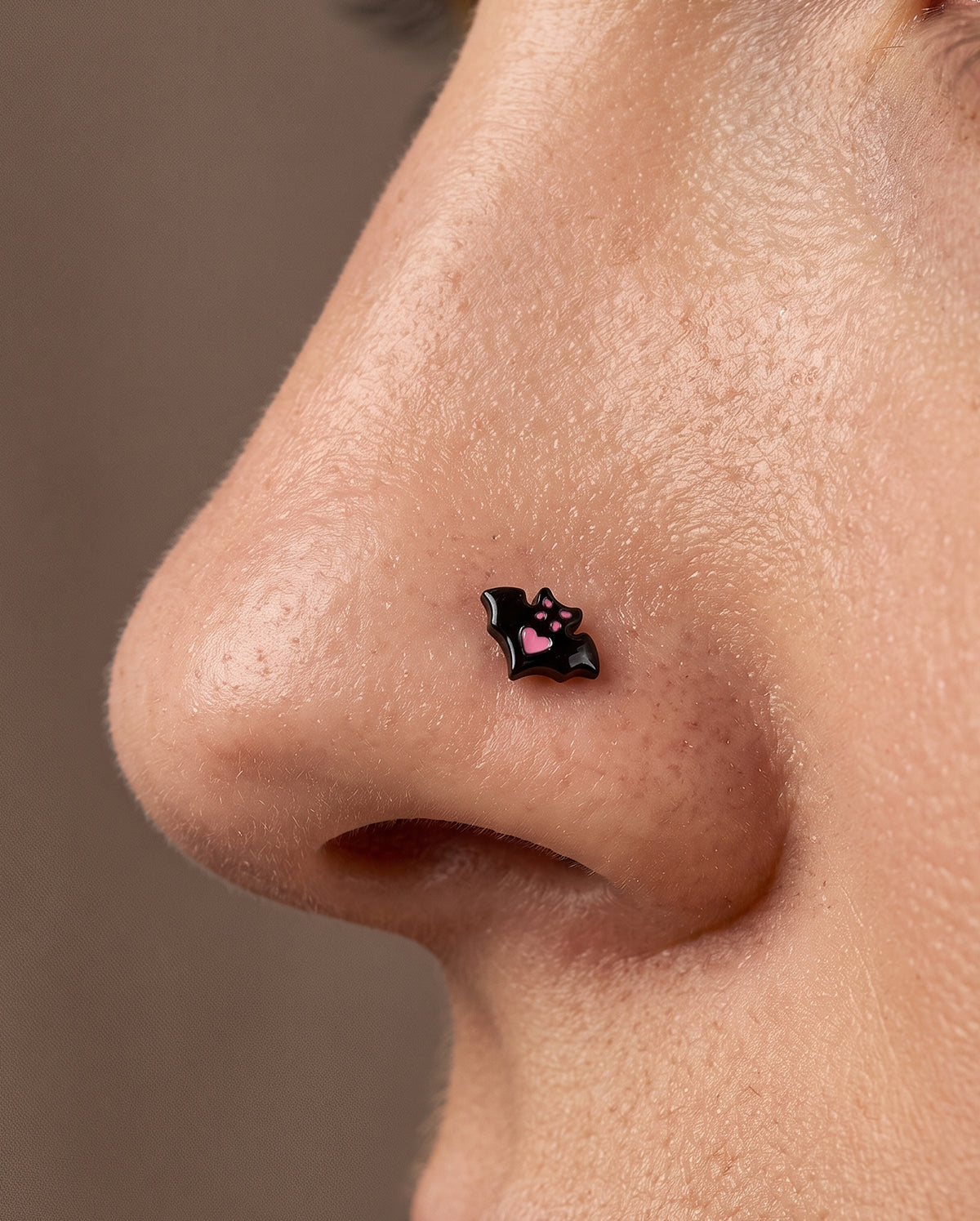 pink bat nose piercing